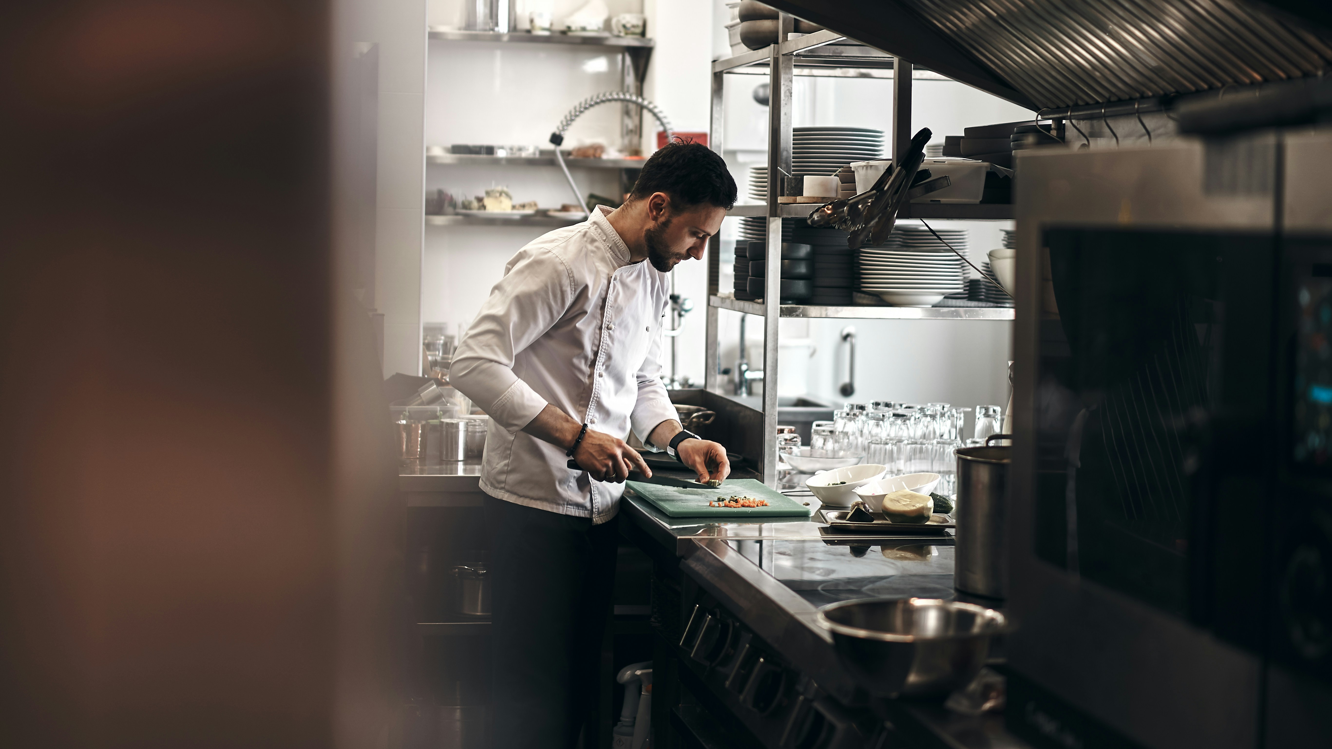 Chef preparing food in a professional restaurant kitchen